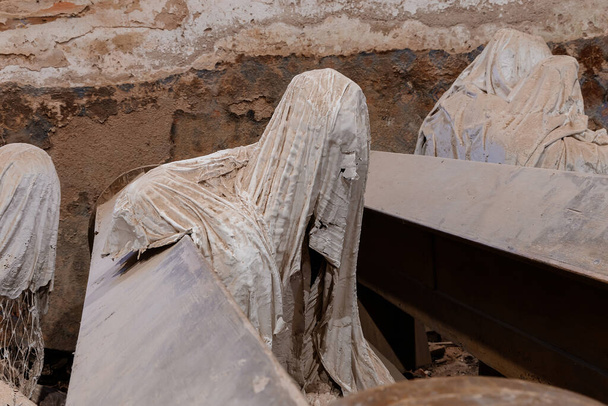 Lukova, Czech Republic, 29 October 2023: Abandoned catholic church of St. George or Jiri, Ghosts line pews, statues by Jakub Hadrava, figures made of plaster, Ghostly figures, Spirit at mass - Photo, Image