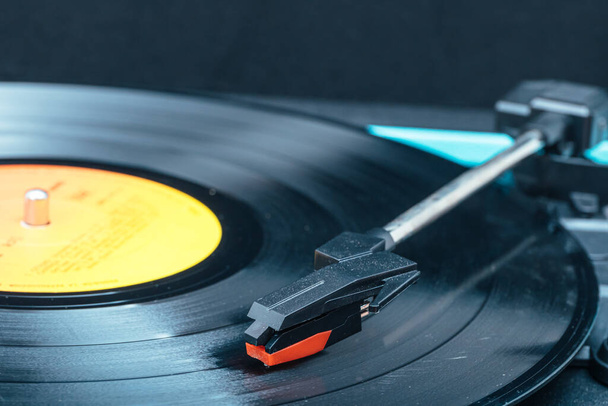 Extreme close up horizontal photo of a vinyl on a blue turntable. Copy space. Concept hobbies, art. - Photo, Image