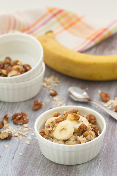 Oatmeal with banana, honey and walnuts for breakfast - Photo, Image