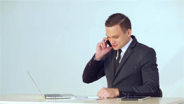 Smiling young businessman making a phone call - Footage, Video