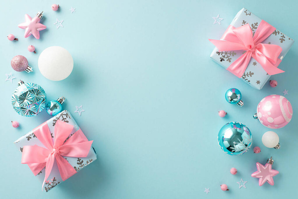 Elegant winter holiday celebration with trendy decorations theme. Overhead shot of baubles, stars, gift boxes with bows, mistletoe berries, confetti on pastel blue backdrop, room for text or ad - Photo, Image