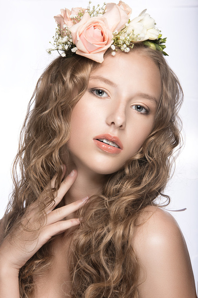 Beautiful girl with flowers in her hair and pink makeup. Spring image. Beauty face. - Photo, Image