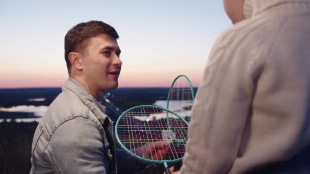 A man holding a tennis racquet on top of a hill - Footage, Video