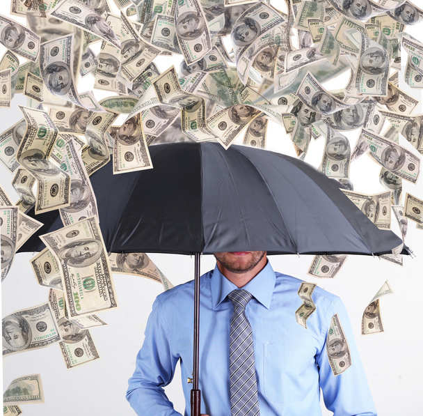 Businessman standing in the rain of money - Foto, imagen