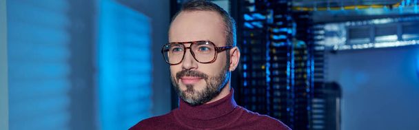 joyful focused data center specialist in turtleneck with beard and glasses looking away, information - Photo, Image