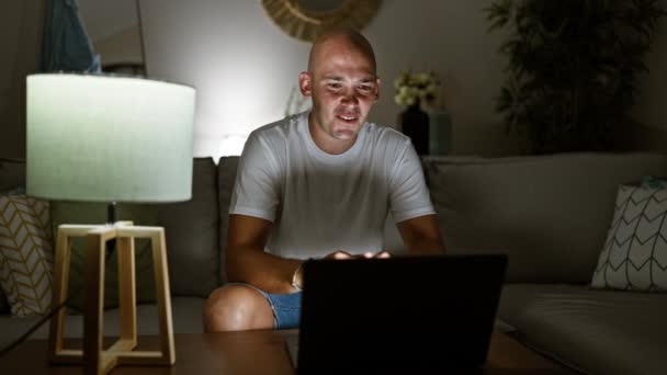Young hispanic man having video call sitting on sofa at home - Footage, Video