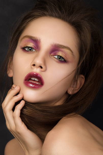 Beauty portrait of young brunette woman with modern salon makeup - Fotó, kép