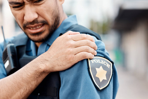 Shoulder pain, man or police officer with injury from accident crime, crisis danger or gunshot emergency in city. Law, arm or injured security guard with painful joint, inflammation or wound in town. - Photo, Image