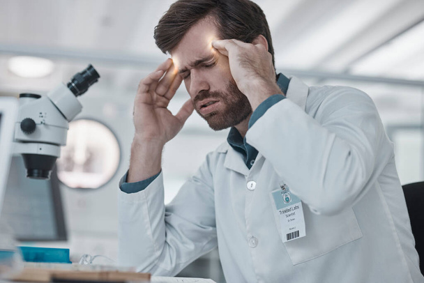 Stress, man or scientist with headache in a laboratory suffering from burnout, migraine pain or overworked. Exhausted, frustrated or tired doctor working on medical science research with fatigue. - Photo, Image