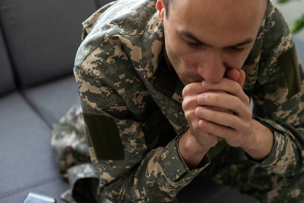 Soldier In Uniform Suffering From Stress. High quality photo - Photo, Image