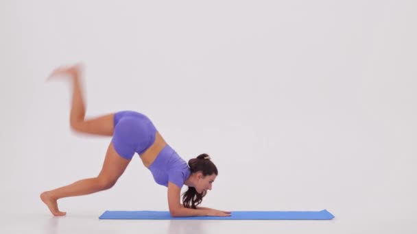 Fitness training. Sportieve vrouw doet stretching in handen op een witte achtergrond. Hoge kwaliteit 4k beeldmateriaal - Video