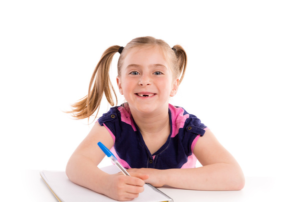 Blond kid girl student with spiral notebook in desk - Фото, изображение