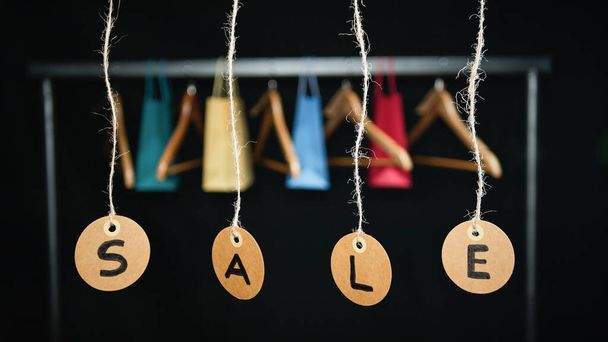 Sale tags with Shopping bags and crutches on background. - Photo, Image