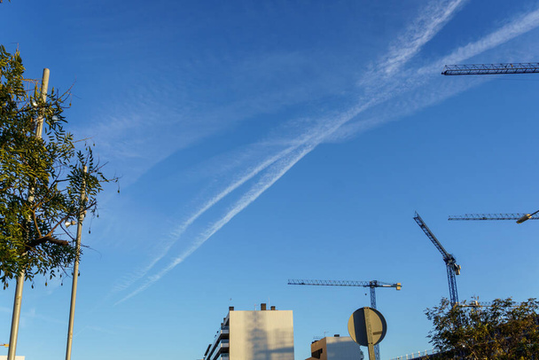 Blue sky with chemtrails. Conspiracy theory of chemtrails. - Photo, Image