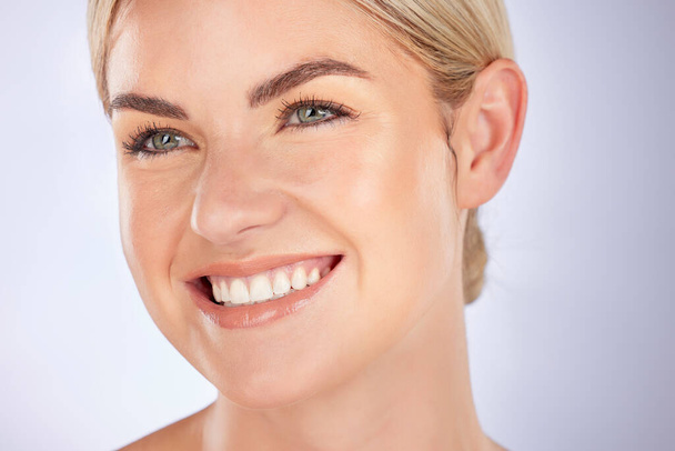 Skincare, smile and face of woman in studio for cosmetic, results or self care on grey background space. Beauty, glowing skin and female wellness model happy with dermatology, shine or skin treatment. - Foto, Imagem