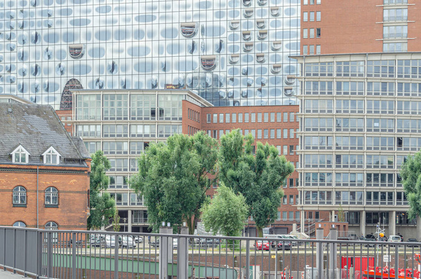 HAMBURG, NIEMCY - LIPIEC 7, 2014: Szczegóły budynków widzianych z portu w Hamburgu, Niemcy, z elewacją Elbphilharmonie (Filharmonia Łaby), nowoczesna sala koncertowa otwarta w 2017 roku - Zdjęcie, obraz