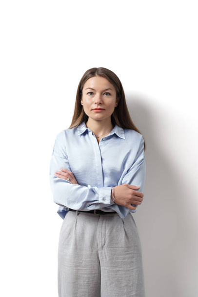 Young caucasian woman, professional entrepreneur standing in office clothing, smiling and looking confident on white background - Photo, Image