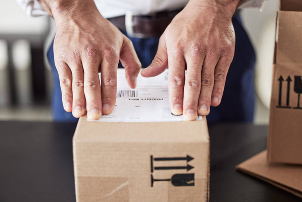 Label, delivery or hands of man with box for courier cargo, ecommerce or supply chain distribution service. Shipping, order sticker or postman sending a store package, freight parcel or mail product. - Photo, Image