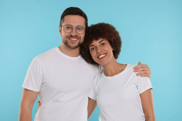 International dating. Portrait of happy couple on light blue background - Fotografie, Obrázek