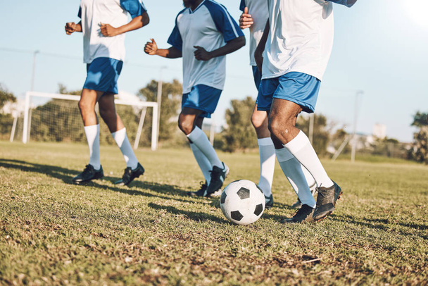 Sports, soccer and team playing on the field at a game competition, league or championship. Fitness, football and male sport players running with a ball at an outdoor match on the soccer field - Photo, Image