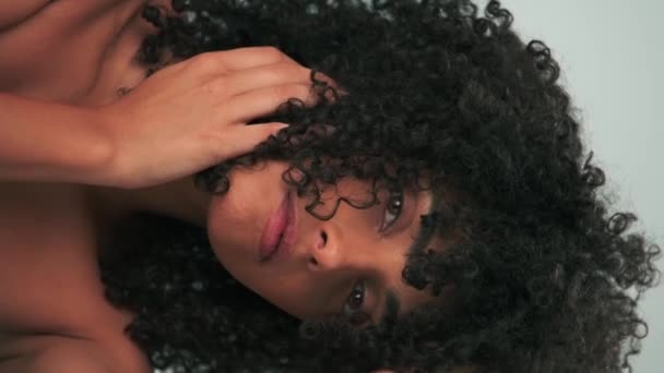 Vertical portrait of young smiling model with curly hair in afro style and bright makeup. Slow Motion, Close Up. - Footage, Video