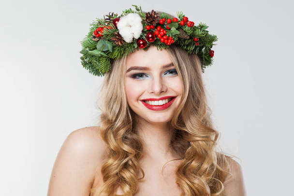 Cheerful blonde woman portrait. Fashion female model with blond curly hairstyle, make-up and green and red winter accessories posing on white background - Fotografie, Obrázek