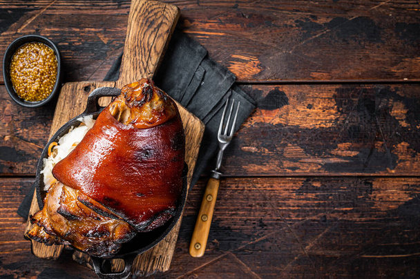 Bavarian Schweinshaxe Roast pork Hock Ham, knuckle with Sauerkraut. Wooden background. Top view. Copy space. - Foto, imagen