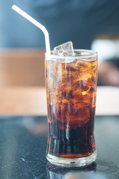 Fizzy soft drink with ice in glass and straw - Photo, Image