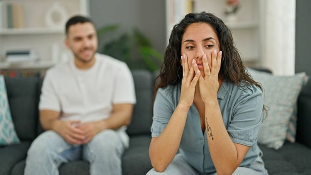 Man and woman couple sitting on sofa arguing stressed at home - Photo, Image