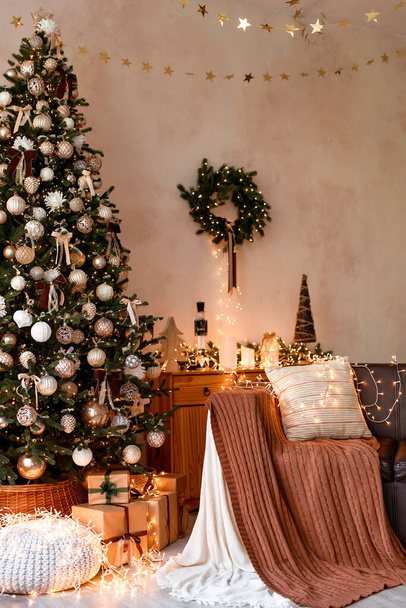 Interior of modern living room with comfortable sofa decorated with Christmas tree and gifts. - Photo, Image