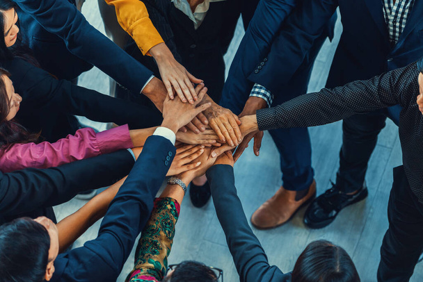A group of diversity people putting their hands together. Showing unity teamwork and friendship. Close up top view of young business man and business woman joining as a team. Intellectual. - Photo, Image