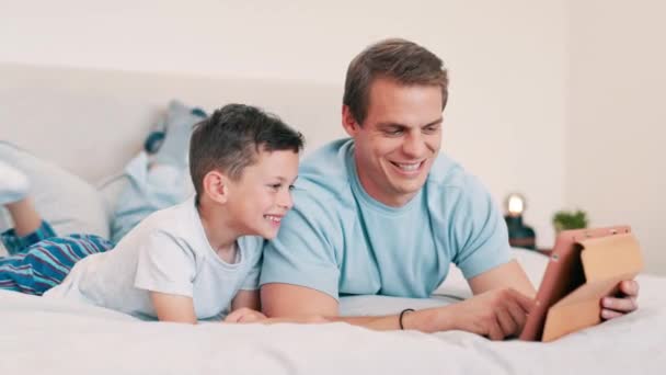 Father, smile and child with tablet in bedroom for online games, download multimedia or reading ebook story. Happy, dad and boy kid streaming cartoon, movies and digital website for elearning at home. - Footage, Video