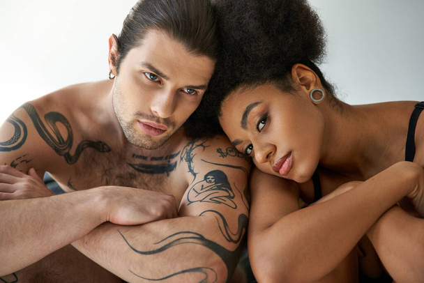 alluring young multiracial couple in underwear sitting close to each other on bed, togetherness - Photo, Image