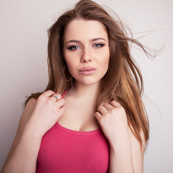 Studio portrait of young sensual & beauty model girl in pink t-shirt. - Photo, image