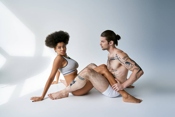 appealing young multicultural couple in sexy comfy underwear sitting on floor, togetherness - Photo, Image