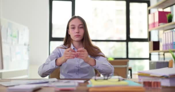 Female worker meditating during coffee break in company premise. Lady takes care for mental health through meditation practice at workplace slow motion - Materiał filmowy, wideo