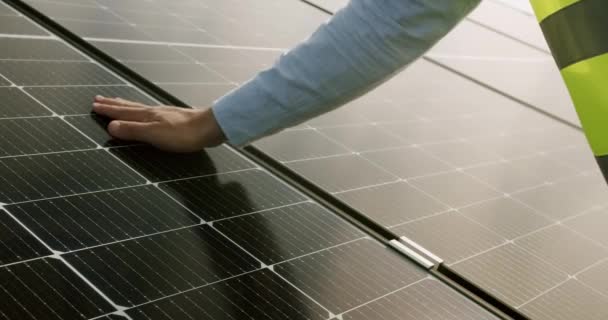 Κλείσιμο του μηχανικού χέρι επιθεώρηση ηλιακό πάνελ σε εξωτερικούς χώρους. Άνδρας εργαζόμενος ελέγχει τη λειτουργία του ήλιου και την καθαριότητα των φωτοβολταϊκών ηλιακών συλλεκτών. Έννοια εναλλακτικής ενέργειας - Πλάνα, βίντεο