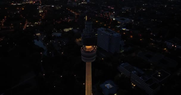 Aerial drone view at night on the broadcasting tv tower of Dortmund, Germany. Florianturm. - Footage, Video