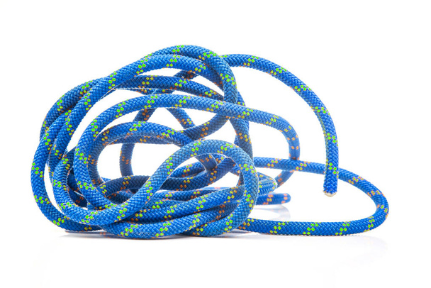 durable colored rope for climbing equipment on a white background. climbing rope. coil of braided cable. item for tourism and travel - Photo, Image