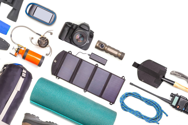 Set of tourist trekking items on white background. Top view of accessories for travel. Equipment for travel and hiking. Survival Items. - Photo, Image