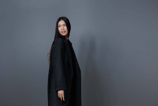 Roztomilý žena podzim vlasy móda šedý úsměv podzim portrét kabát módní krása zimní oblečení asijské brunetka krásný studio dívka model lifestyle - Fotografie, Obrázek