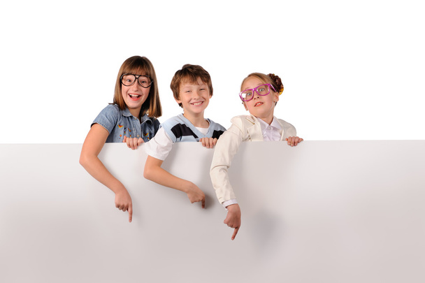 Portrait of happy children with white blank - Photo, Image