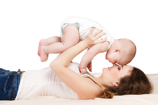 Portrait of happy mother with baby on a white background. - Foto, immagini