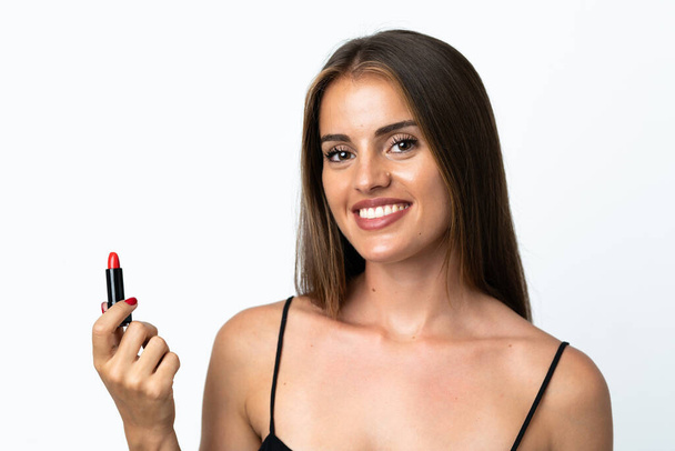 Nuori Uruguayn nainen eristetty valkoisella taustalla tilalla punainen huulipuna - Valokuva, kuva