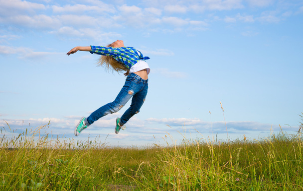 Woman jump in green grass field - Fotografie, Obrázek