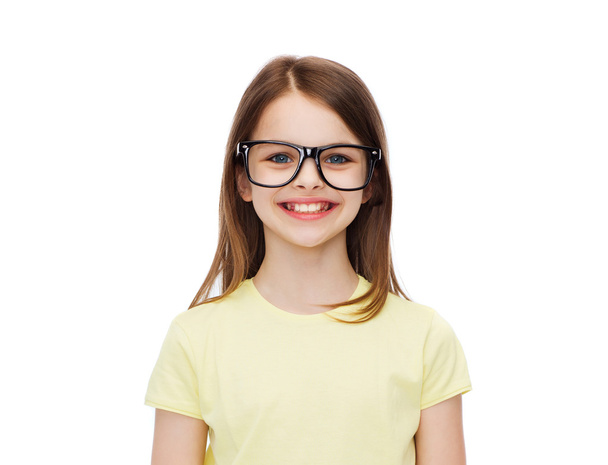 smiling cute little girl in black eyeglasses - Φωτογραφία, εικόνα