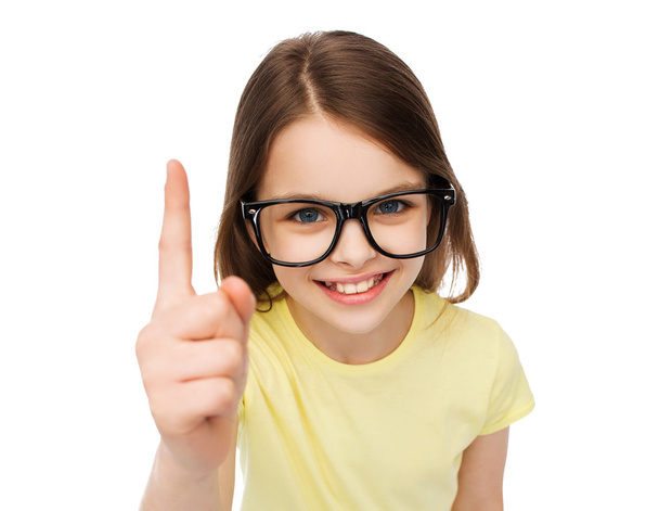 smiling cute little girl in black eyeglasses - Foto, Imagen
