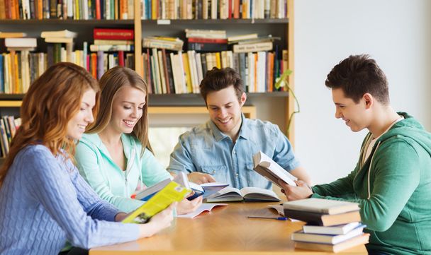 students with books preparing to exam in library - Foto, Imagen