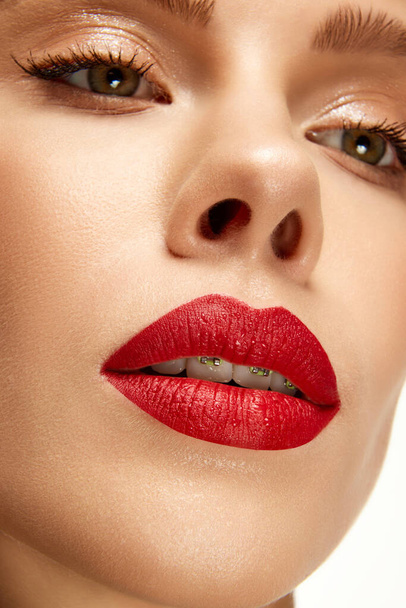 Cropped photo of beautiful woman with bright fashion make-up. Red lip matte lipstick. Female full plump sexy lips. Concept of beauty, make-up, cosmetology, spa treatments, cosmetic products. Ad - Photo, Image