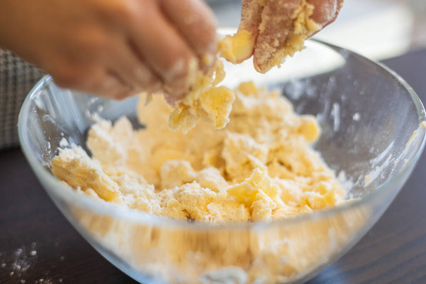 Divertimento culinario creativo: mani di bambino che creano crosta corta cruda per mini crostate - Foto, immagini
